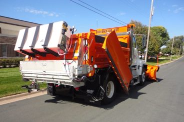 Heavy duty truck upfit with Henderson snow plow and stainless steel body, wing plow, salt/sand spreader, and pre-wet system