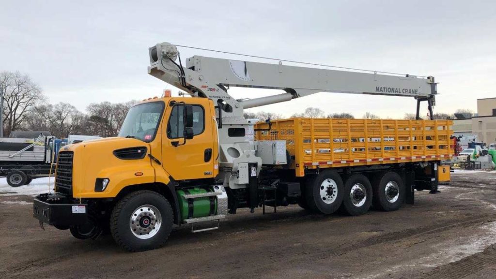 Freightliner 108SD, National NBT30 crane, 60,000 lbs capacity, 100 ft reach, 20 ft flatbed with storage, DMF hi-rail, 5/10 GPM tool circuit, strobe and spot light package