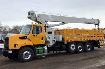 Freightliner 108SD, National NBT30 crane, 60,000 lbs capacity, 100 ft reach, 20 ft flatbed with storage, DMF hi-rail, 5/10 GPM tool circuit, strobe and spot light package