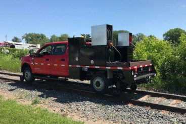 Purpose-built Ford F-550, 9 ft flatbed with storage boxes, 5/10 GPM tool circuit, Harsco hi-rail, strobe and spot light package