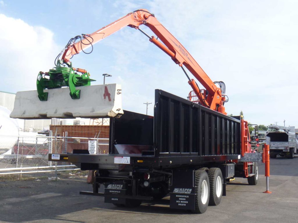 Serco 230B 23,000 lbs. capacity material grapple loader with jersey barrier handling attachment