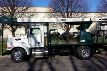 Rear-mounted Versalift VO-260 over-center aerial device with custom ground mat storage