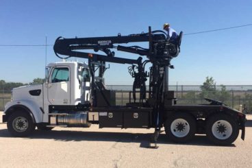 Tractor-mounted Serco 160 loader with pole grapple and purpose-built 5th wheel body