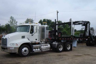 Trailer-mounted Serco 8500 material loader with tractor wet-kit and cab tool box