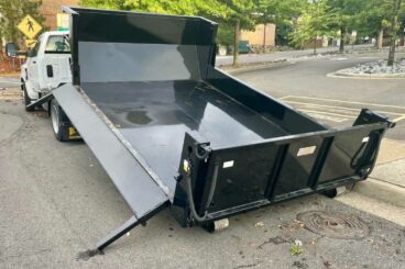 Switch-N-Go dump body with drop down sides, board pockets and 50-degree dump angle