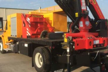 Purpose-built custom body, rear mount Palfinger knuckleboom crane, flatbed chassis, rear outriggers