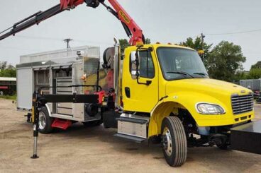 Custom sign truck with knuckleboom crane, custom aluminum body, outriggers