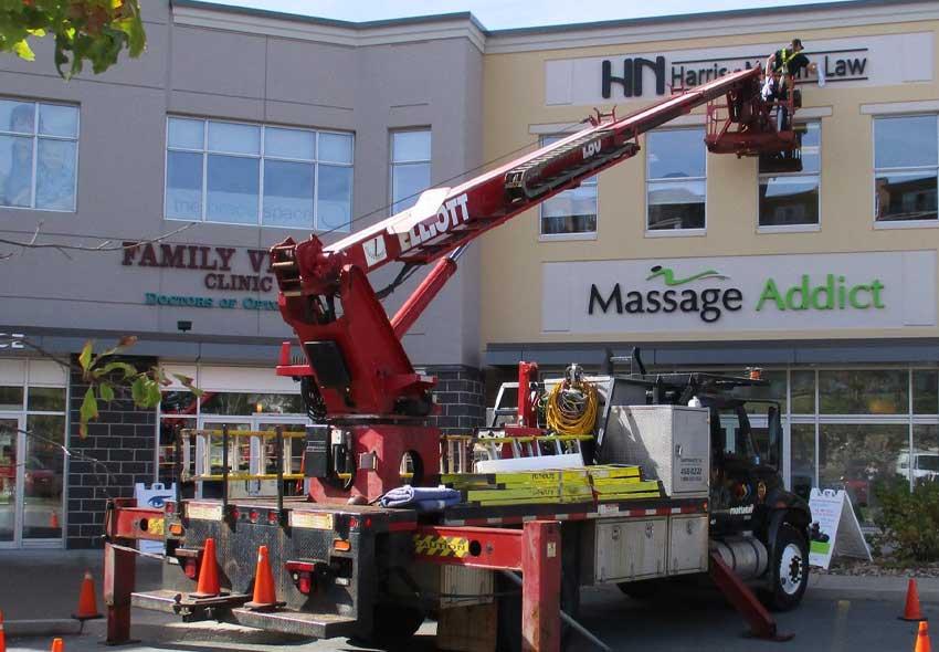 Insulated utility work truck upfit with Versalift 37 ft aerial bucket, service body and custom tailshelf.