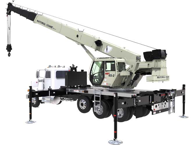 Boom truck crane with tri-axle and extended outriggers