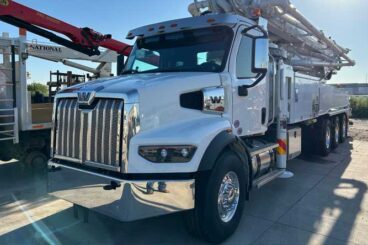 Concrete boom pump truck equipment. Front shows a Western Star cab.