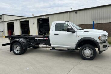 White RAM 5500 standard cab dually work truck with Switch-N-Go hooklift system upfit.