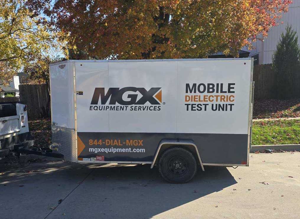 Single axle utility trailer with MGX Equipment Services logo, Mobile Dielectric Test Unit descriptive text, phone number and website address.