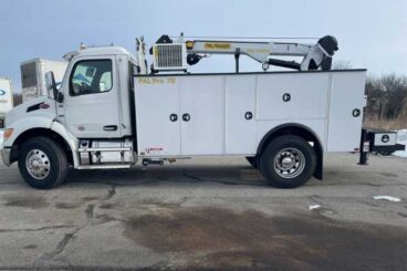 White large mechanics work truck parked outdoors on concrete with PAL Pro 72 branding and a service crane