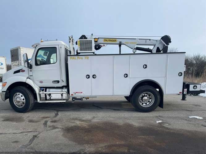 White large mechanics work truck parked outdoors on concrete with PAL Pro 72 branding and a service crane