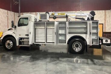 White heavy-duty mechanics truck with Palfinger body and crane in industrial building