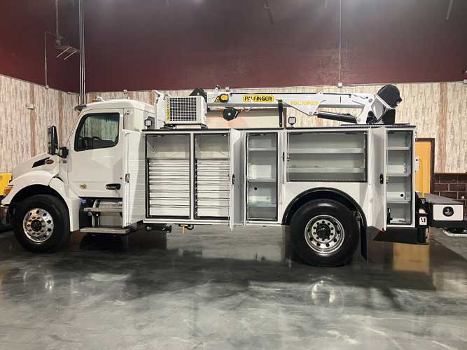 White heavy-duty mechanics truck with Palfinger body and crane in industrial building