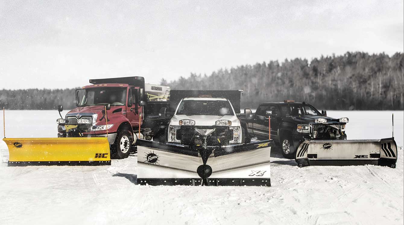 Line-up of Fisher brand snow plows on a snowy surface.
