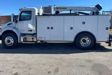 White Peterbilt heavy-duty work truck with PAL Pro 72 mechanics body and service crane parked outdoors under blue skies