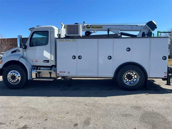 White Peterbilt heavy-duty work truck with PAL Pro 72 mechanics body and service crane parked outdoors under blue skies