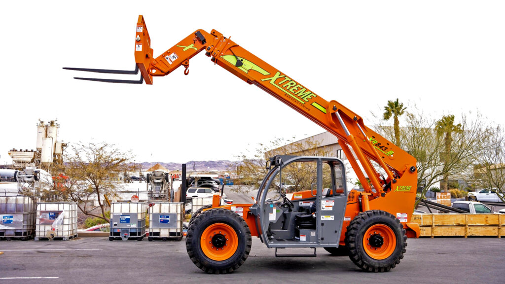Xtreme Manufacturing brand telehandler machine with raised forklift boom on industrial lot.