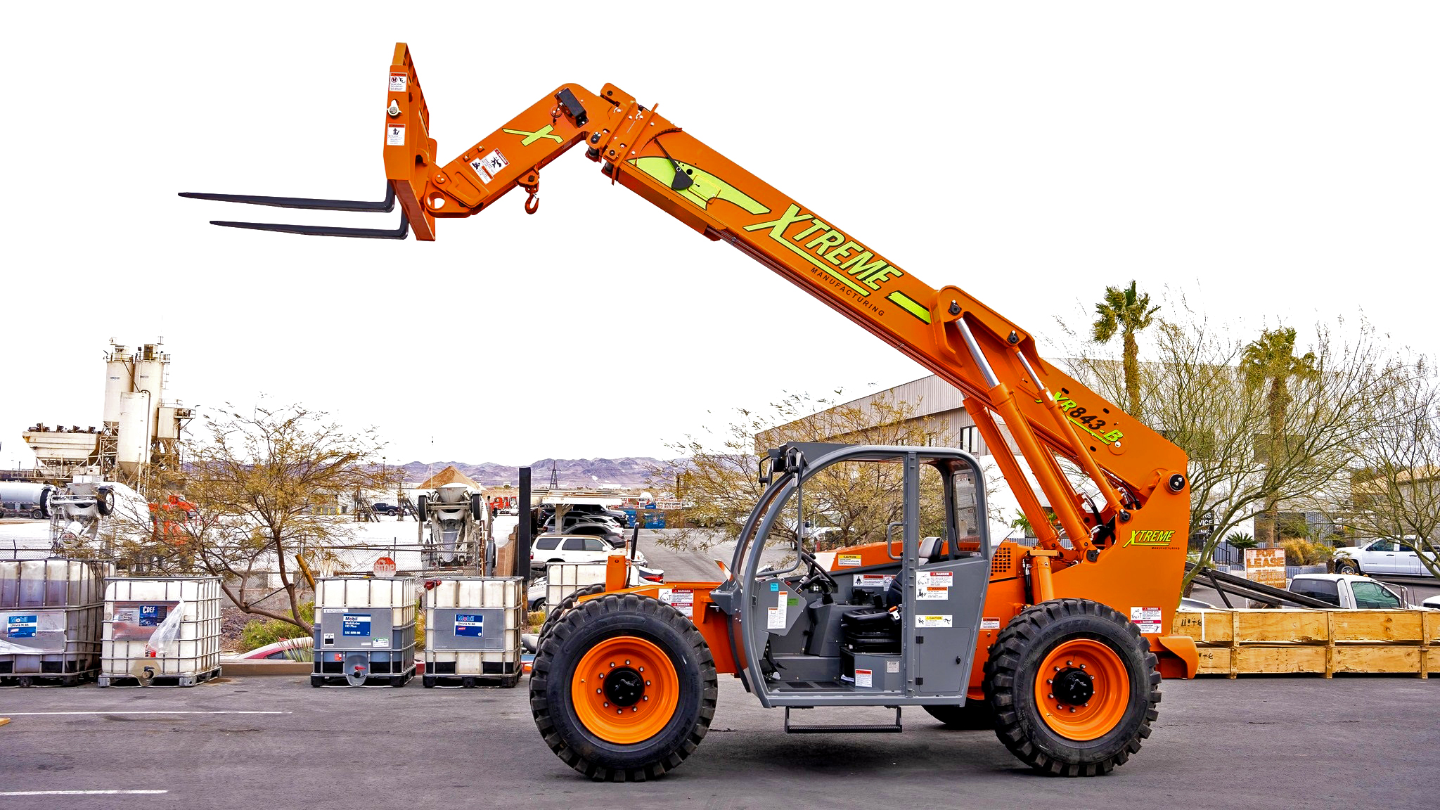 Xtreme Manufacturing brand telehandler machine with raised forklift boom on industrial lot.