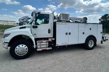 White commercial truck with PAL Pro 72 mechanics body parked outdoors on gravel. Compressor and service crane mounted on service body.