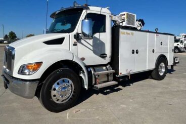 White industrial standard cab work truck with PAL Pro 72 wording on the mechanics body parked outdoors under blue skies.