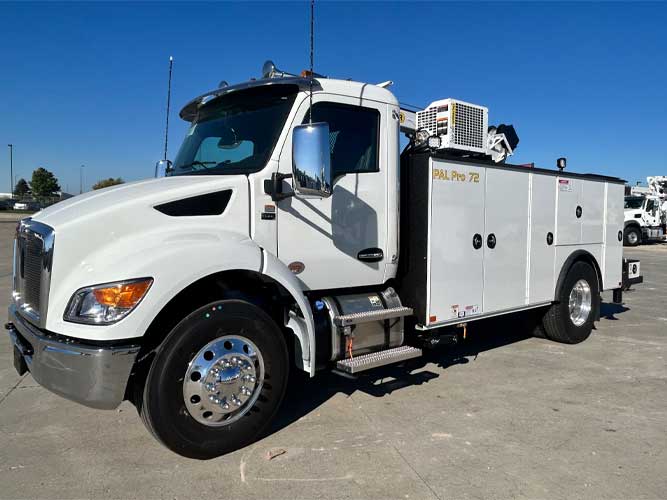 White industrial standard cab work truck with PAL Pro 72 wording on the mechanics body parked outdoors under blue skies.